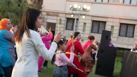 Women holding sticks in their hands and dancing